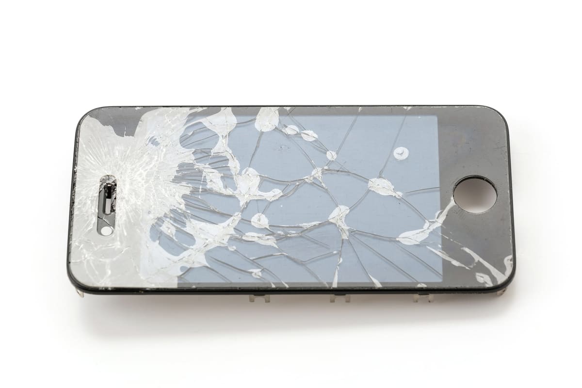 A mobile phone with a shattered screen