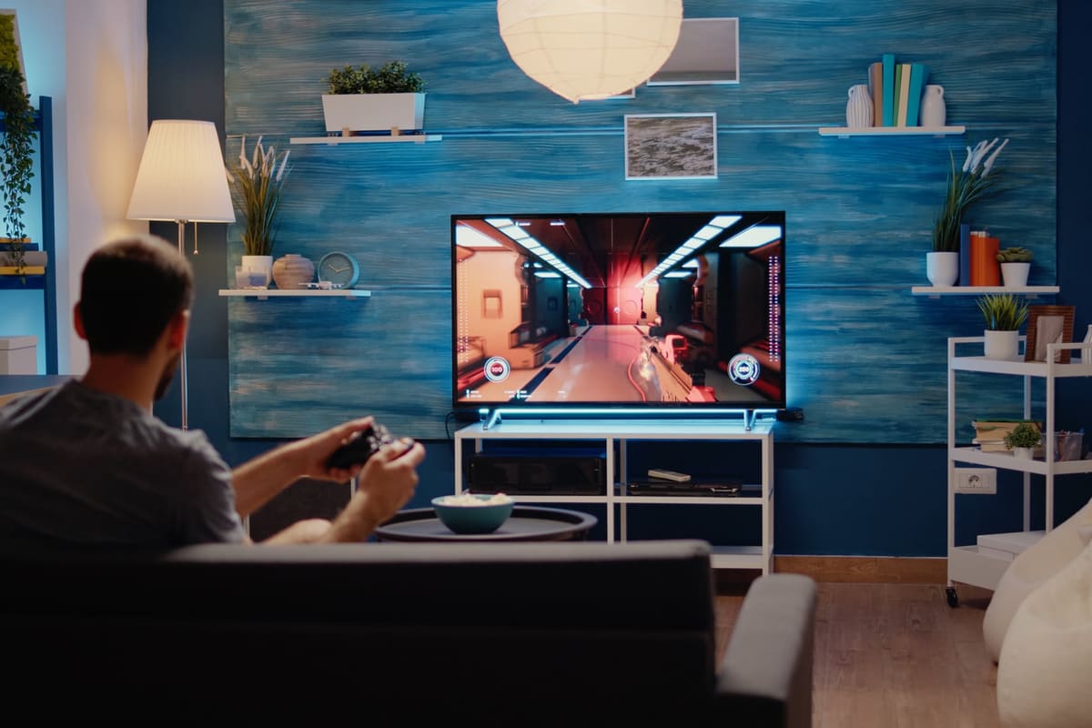 A man playing an action game on a TV console