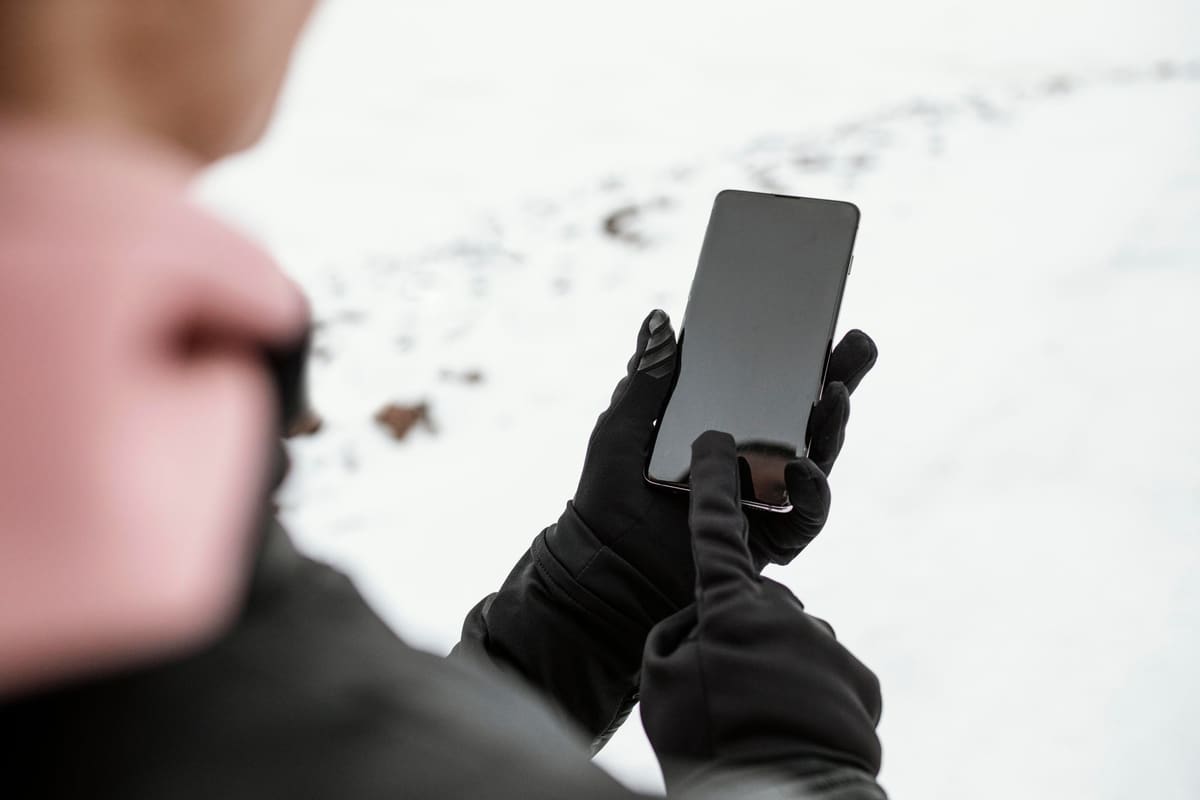 Close-up of two hands holding a smartphone
