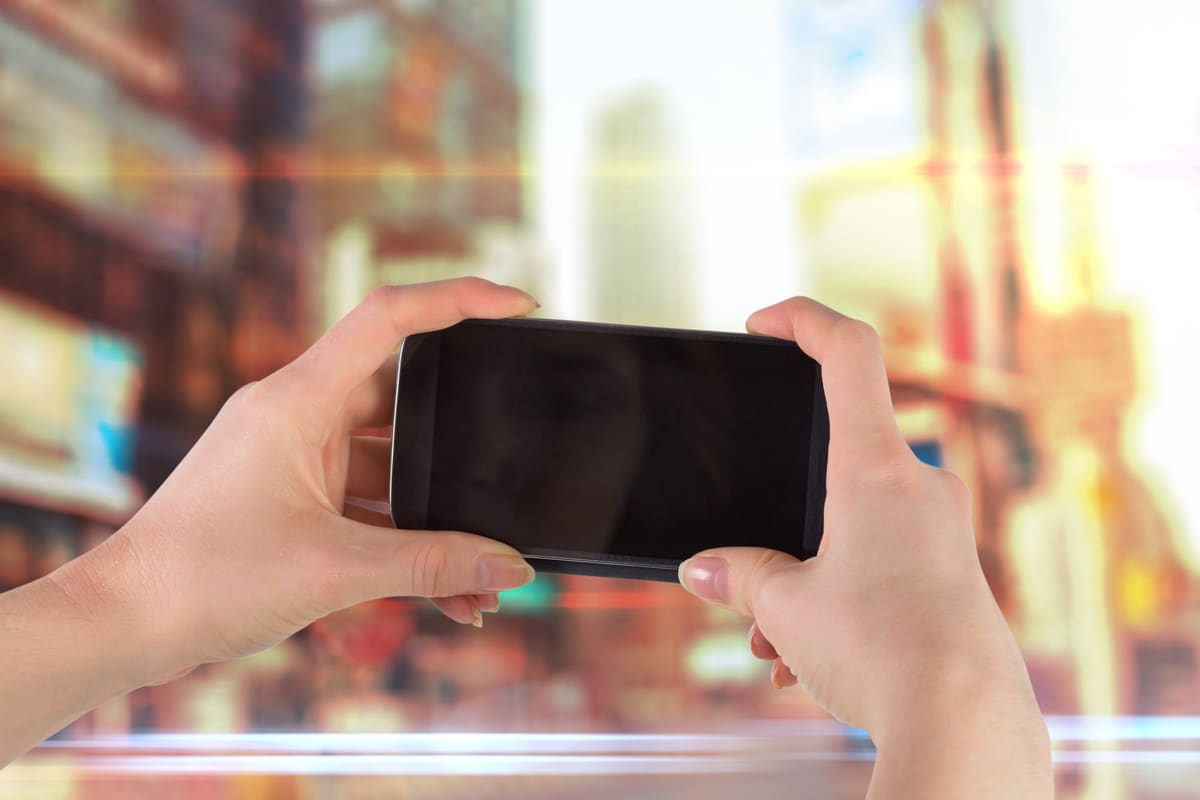 Hands holding a smartphone up to take a photo